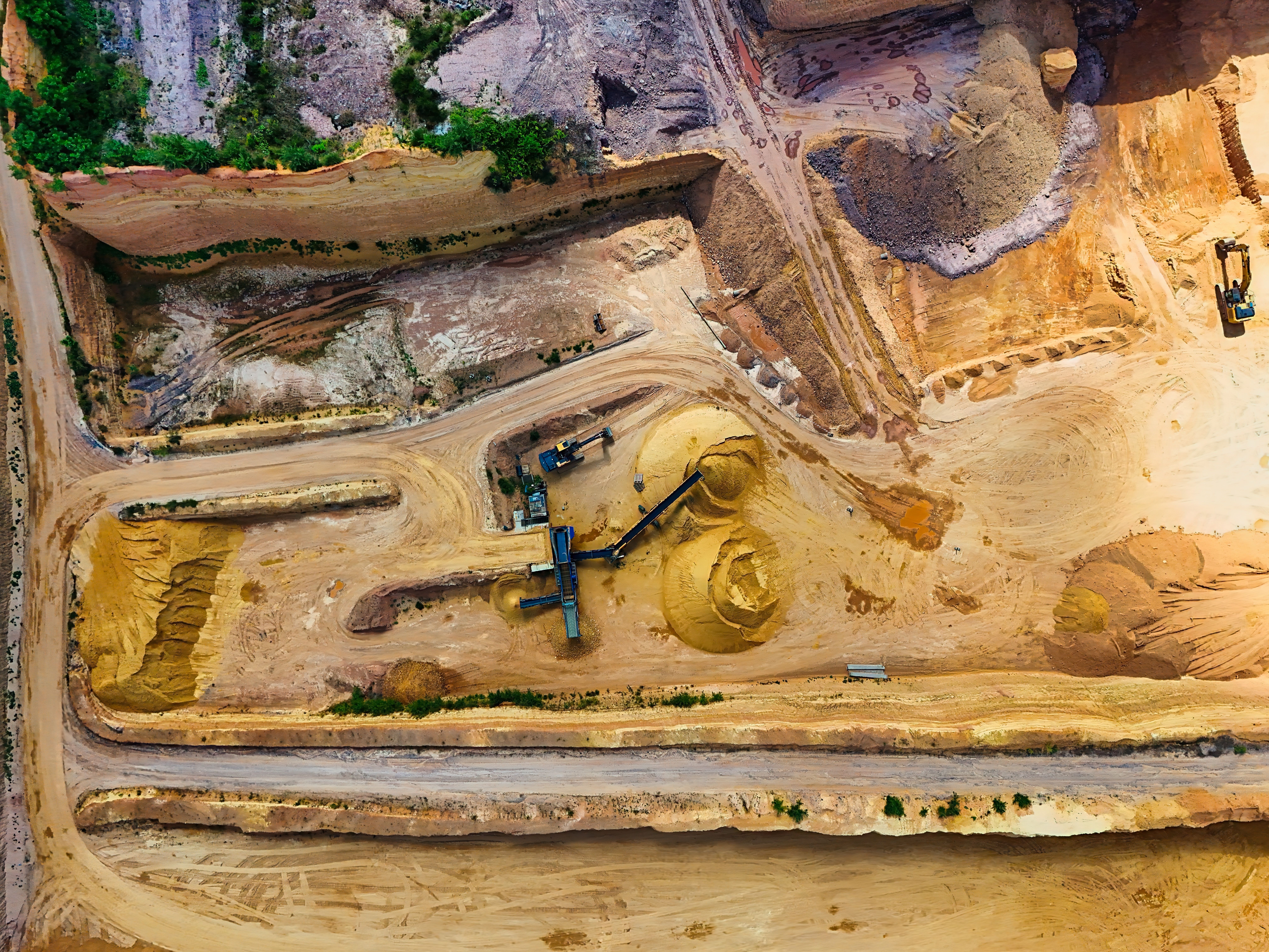 Open quarry with material-processing equipment