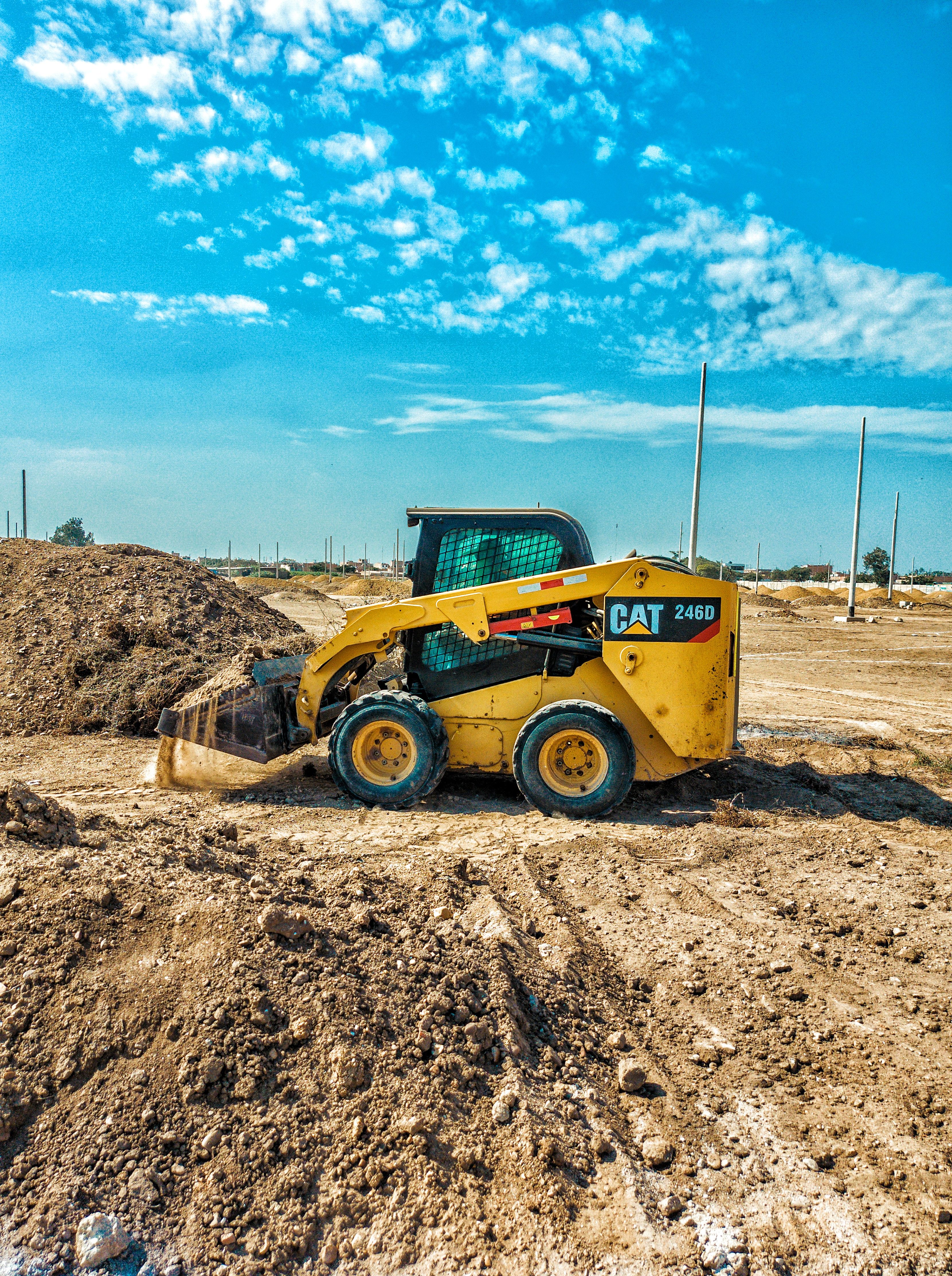 Compact loader at a worksite